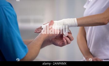 L'orthopédiste élastique poignet enrouler sur le main patiente dislocation mixte Banque D'Images