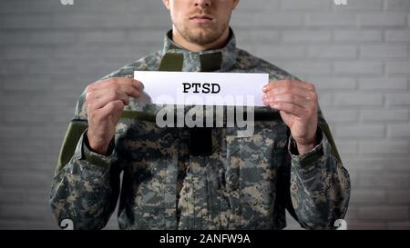 L'ÉSPT written on sign in hands of male soldier, le trouble post-traumatique, santé Banque D'Images