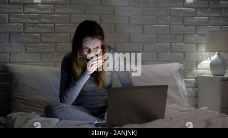 Student girl doing projet sur ordinateur portable de nuit réunion date limite, préparation aux examens Banque D'Images