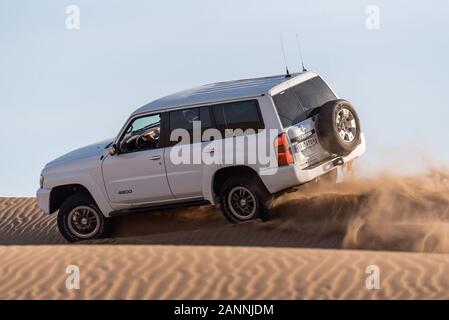 white nissan patrouille super safari escalade dune sable barbotage sable autour dans dasht e lut ou sahara désert Banque D'Images