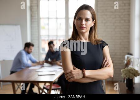Head shot portrait confiant belle businesswoman with arms crossed Banque D'Images