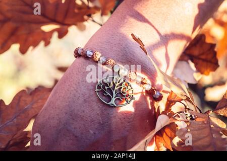 Homme de main poignet en automne nature avec pierre labradorite perles rudraksha minéral et métal bracelet pendentif en cuivre Banque D'Images