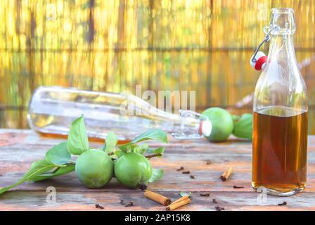 Une bouteille de cidre de pomme. Still Life, de mal dispersés demi-bouteilles vides avec le vinaigre de cidre de pomme. Composition avec des lunettes, les décorations de la cannelle Banque D'Images