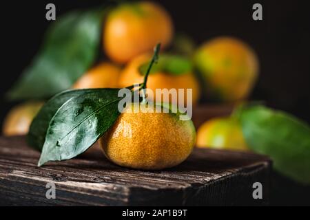 Mandarine avec des feuilles sur un pays à l'ancienne table. Focus sélectif. L'horizontale. Banque D'Images