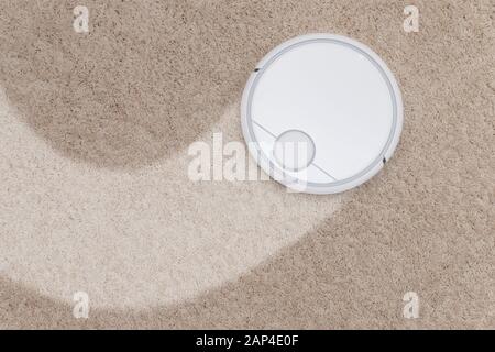 Aspirateur intelligent sans fil robotisé fonctionnant sur blanc avec tapis en pile Banque D'Images