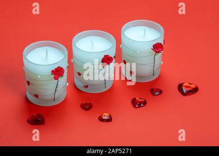 Aroma candles décoré de roses et coeurs sur fond rouge. Valentines Day. Banque D'Images