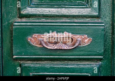 Boîte aux lettres en cuivre espagnole typique sur porte verte en bois Banque D'Images