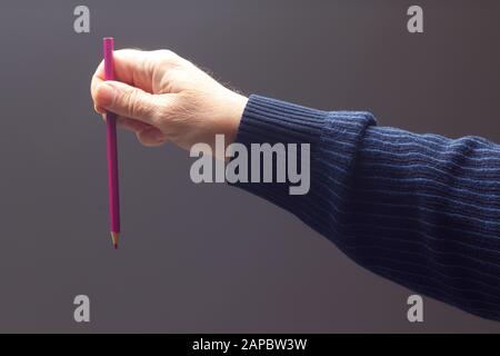 couleurs avec le point vif, groupe de couleurs unis dans la main d'une personne adulte; couleurs assorties dans différents crayons Banque D'Images