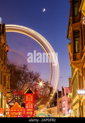 Ferry Wheel dans le centre-ville de Wiesbaden, au milieu de vieux bâtiments, la nuit avec la lune sur le ciel Banque D'Images