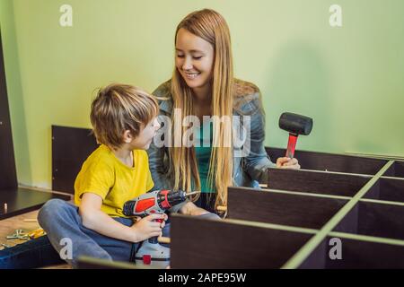 Mère et fils assemblant des meubles. Garçon aidant sa mère à la maison. Concept de famille heureuse Banque D'Images