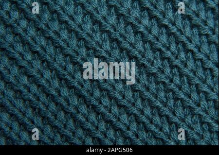 Texture d'un pull bleu-vert tricoté en laine. Toile turquoise fond Banque D'Images