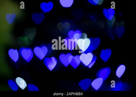 Arrière-plan de Valentines. Cœur abstrait bokeh arrière-plan. Lumières floues en forme de coeur floues. Contexte de la Saint Valentin Banque D'Images