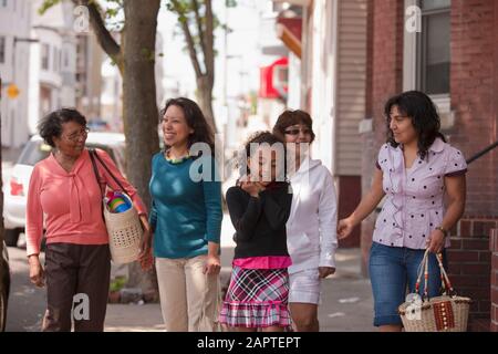 Les femmes de trois générations passent du temps ensemble à descendre un trottoir Banque D'Images