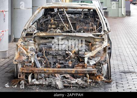 Une voiture brûlée se trouve sur le trottoir d'une rue de la ville, vue de face d'un habitacle brûlé. Banque D'Images