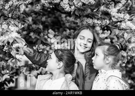 Offres fleurs fleur. Les enfants peuvent s'amuser à fleur de cerisier. La véritable amitié. Pink notre préféré. Les enfants jardin de printemps. Sakura garden. Soeurs amis arbres de sakura l'arrière-plan. Les enfants des fleurs roses du sakura arbre. Banque D'Images