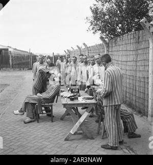 Reportage du camp de Vught Dans le camp criminel de Vught, 7000 collaborateurs et traîtres néerlandais sont enfermés. Les soldats des Néerlandais Stoottroopers sont en charge de la garde, en particulier des 300 Néerlandais SS. Sous la direction du commandant du camp, Le Major L. Mennes et ses aides, ces prisonniers sont utilisés pour purifier les environs de Vught des mines terrestres. Ils sont habillés dans les paquets de prison à rayures bleu-blanc de l'ancien néerlandais capturé par les Allemands. Les prisonniers reçoivent la ration civile minimale, qui a également été réduite, parce que toutes les friandises ont été supprimées Banque D'Images