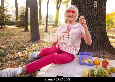 Une dame gaie qui passe du temps pour pique-nique Banque D'Images