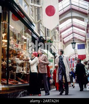 Londres 1970, élégant couple mature shopping pour la vaisselle, Burlington Arcade, Piccadilly, Mayfair, Angleterre, Royaume-Uni, GB, Grande-Bretagne, Banque D'Images