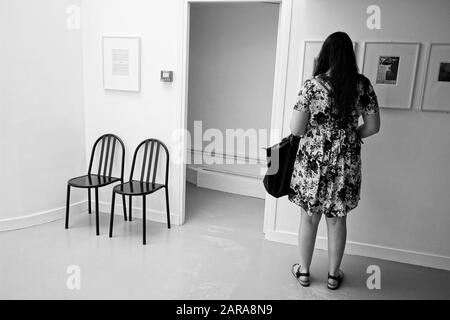 Femme avec exposition de visite des sacs, deux fauteuils design, Musée Henri Cartier Bresson, Paris, France, Europe Banque D'Images