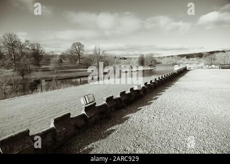 Vue depuis le château de Ripley d'un lac et d'une forêt en arrière-plan lors d'une journée d'hiver ensoleillée en janvier, Ripley, North Yorkshire, Angleterre, Royaume-Uni. Banque D'Images