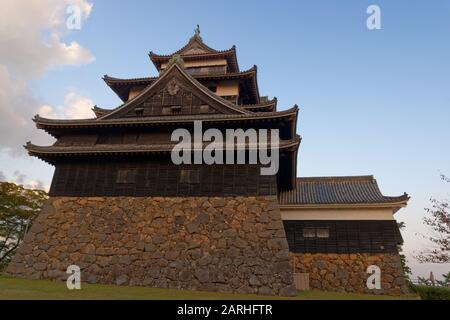 Le château de Matsue, également appelé château noir, au coucher du soleil. Le château de Matsue est l'un des rares châteaux originaux du Japon. Banque D'Images