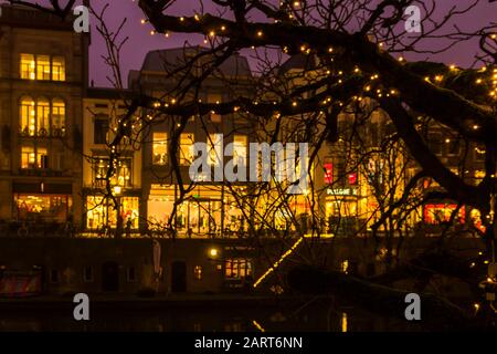 Utrecht, Pays-Bas, 21 Janvier 2020. Un pont en pierre à l'arc traversant le canal, dans le centre d'Utrecht. Soirée Misty, vue de nuit sur le canal, vieux néerlandais h Banque D'Images