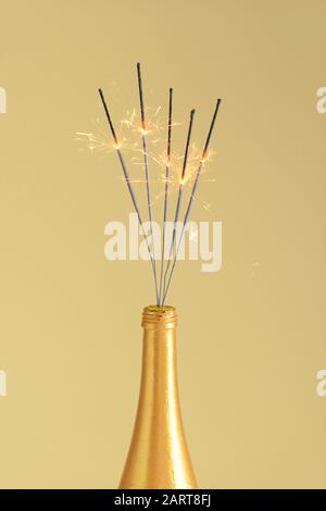 Bouteille de champagne avec parciateurs de Noël festifs sur fond de couleur Banque D'Images