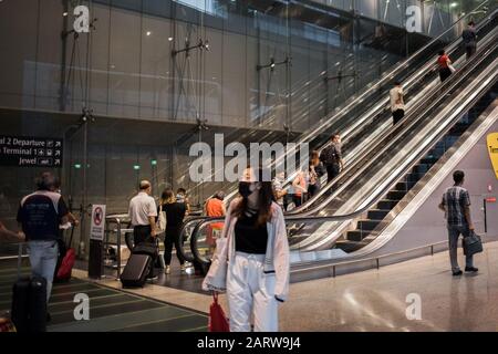 On voit des gens porter des masques de protection lorsqu'ils marchent autour de l'aéroport de Changi à Singapour.Beaucoup de gens ont commencé à porter des masques de protection dans de nombreux endroits du monde en raison de la peur de l'éclosion de coronovirus Wuhan. Dix personnes ont été testées positives pour le coronavirus de Wuhan à Singapour le 29 janvier 2020, comme l'a indiqué le Ministère de la santé du pays. Banque D'Images