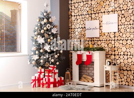 Intérieur de la chambre avec arbre de Noël décoré et cheminée Banque D'Images