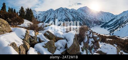 Panorama du lever du soleil sur un lac de montagne en hiver. Matin hiver paysage de montagne. Grand Lac D'Almaty. Kazakhstan Banque D'Images