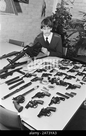 L'usine d'armes illégales de Diemen s'est déroulée et une grande quantité d'armes et de munitions a été saisie. Policiers aux armes au poste de police/ Date : 1er mars 1982 lieu : Diemen mots clés : armes Banque D'Images