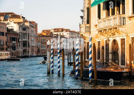Pieux d'amarrage en bois et bateau le long du Grand Canal, Venise, Italie Banque D'Images