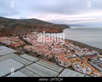 Point de drone aérien de la photo Calahonda petite ville en Andalousie. Greehouses et toits de bâtiments résidentiels pittoresque mer calme mer, Espagne Banque D'Images