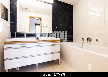 salle de bains avec miroir et deux lavabos et baignoire Banque D'Images