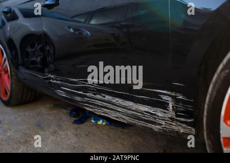 un pneu cassé après un accident.une voiture après un accident une porte rayée avant de peindre Banque D'Images