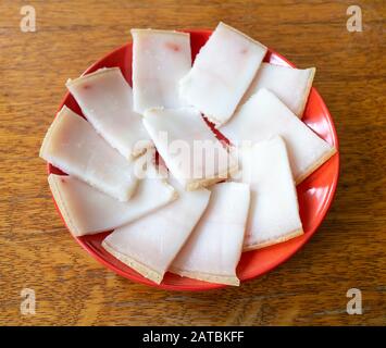 Le bit FAT présente sur la table. La plaque rouge sur table en bois.Tranches blanches Salées Banque D'Images