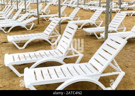 Chaises de plage en dehors de la saison. Transats vides sur une plage de sable. Banque D'Images