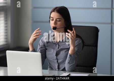 Une femme portant un casque fournit une assistance technique au centre de service à la clientèle Banque D'Images