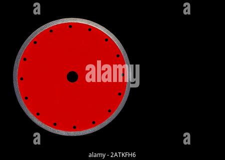 Disque de coupe pour une coupe précise de la couleur rouge de granit avec un diamètre de diamant de 230 mm isolé sur le fond noir. Banque D'Images