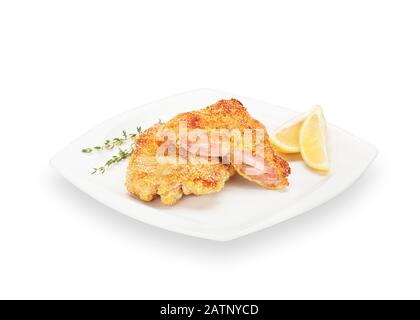 Poulet croustillant au poulet grillé sur une plaque blanche avec des tranches de citron et du thym. Viande Croquante Panée Faite De Pattes De Poulet. Banque D'Images