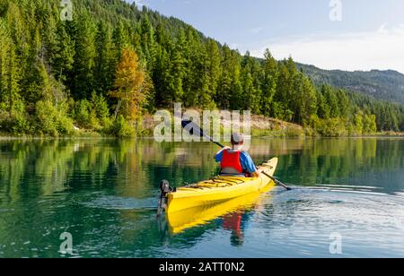 Un adolescent qui fait du kayak sur White Lake, dans le parc provincial de White Lake; Colombie-Britannique, Canada Banque D'Images