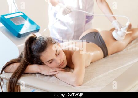 Cosmétologie matérielles. Photo de jeune femme aux yeux clos s'rf procédure de levage dans un salon de beauté Banque D'Images