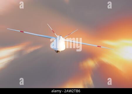 Une drone militaire sans pilote patrouille dans le ciel au coucher du soleil. La vue est tout droit Banque D'Images