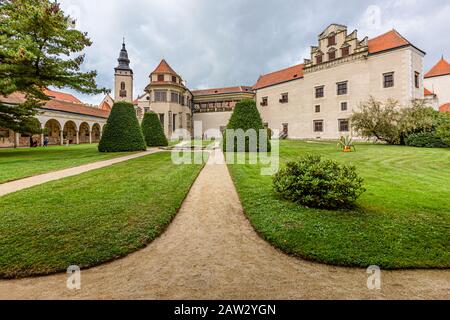 Telc / République tchèque - 27 septembre 2019: Vue sur un château appartenant à l'État et une église de James le Grand d'un jardin avec herbe verte, buissons. Banque D'Images