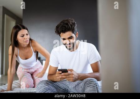 Les jeunes choqués masturbations mari triche sur son amant avec messages snooping sur smartphone Banque D'Images
