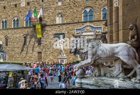 Le lion Medici de Flaminio Vaccaa à Logia dei Lanzi sur fond de la réplique de David de Michel-Ange, Piazza della Signoria, Florence, T Banque D'Images
