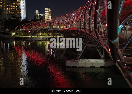 Singapour, Avril 2019. Le pont Helix la nuit, officiellement L'Helix, et précédemment connu sous le nom de pont Double Helix, est un pont piétonnier linki Banque D'Images
