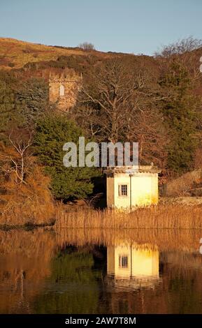 Duddingston, Édimbourg, Écosse, Royaume-Uni. 7 février 2020. Température fraîche de -1 centrigrade, réflexions sur le Loch Duddingston de la Tour de Thomson et le jardin du Dr Neil avec Duddingston Kirk. La tour de Thomson a été conçue par William Henry Playfair et construite en 1825 pour que la Duddingston Curling Society stocke ses pierres. L'étage supérieur était à la fois un lieu de rencontre pour les joueurs de curling et un studio pour l'artiste respecté le Rév. John Thomson, ministre de Duddingston de 1805 à 1840. Banque D'Images