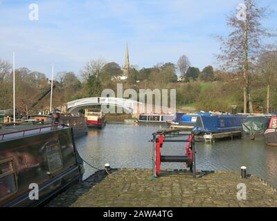 Vue sur la marina de Braunston, un carrefour animé où le canal d'Oxford rencontre la Grande Union ; la flèche de L'église De Tous les Saints peut être vue au loin. Banque D'Images