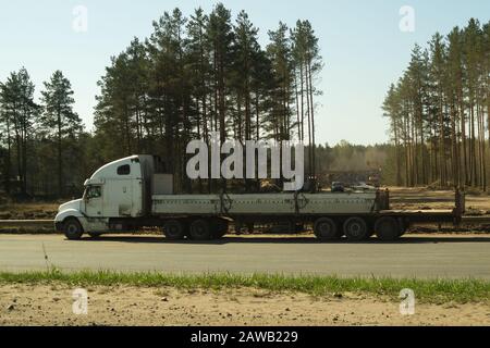 Gros camion sur le bord de la route près de la forêt. Camion blanc sur une route. Véhicule de transport Banque D'Images